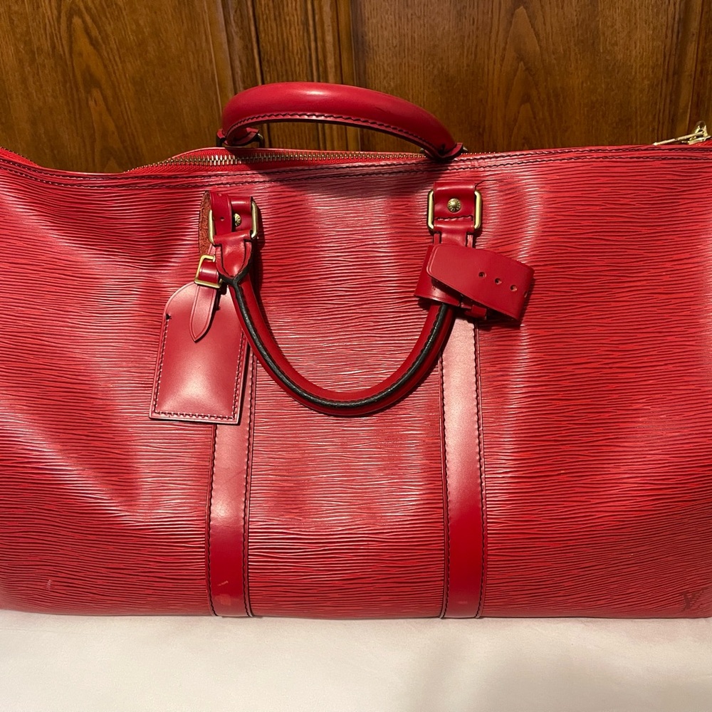 Authentic Pre owned Epi Red travel LV